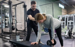 image of sports medicine specialist working with an athlete