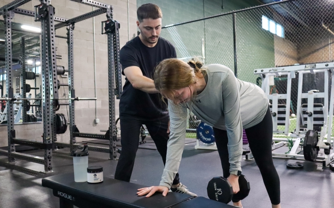 image of sports medicine specialist working with an athlete