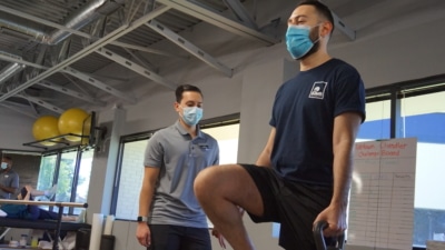 A man doing leg lifts as he holds a kettlebell.