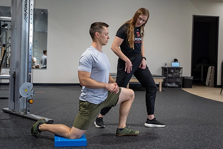 Spooner Rockwall, Physical Therapist working with an athlete