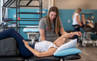 A breast oncology physical therapist working in a breast cancer survivor in recovery.