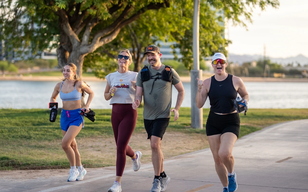 A group of friends running in a park.