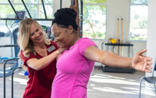 Feature image of a woman stretching with the help of a breast health specialist.