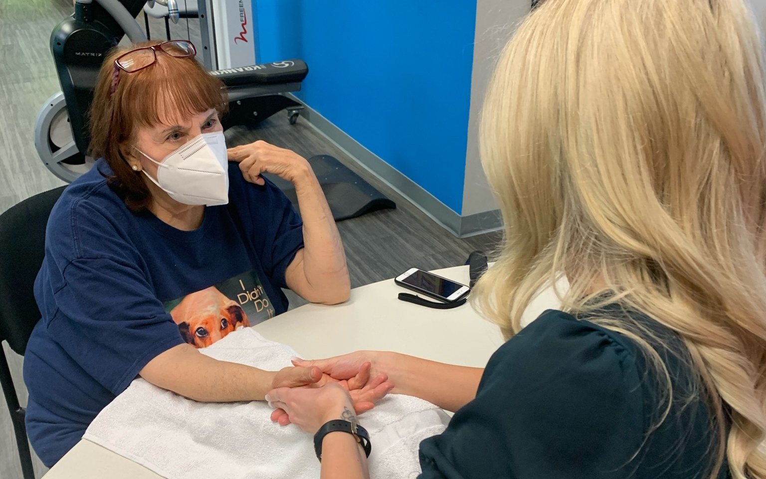 hand therapist Kristin Hazak performs hand therapy on a senior patient at spooner north phoenix