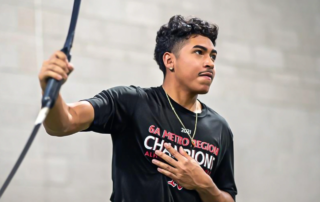 A teen athlete using an elastic bar.