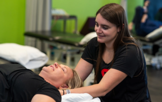 Alix Ungaretti, PT, DPT doing neck manipulation on a female patient.