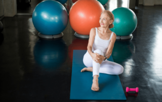 Senior woman on yoga mat