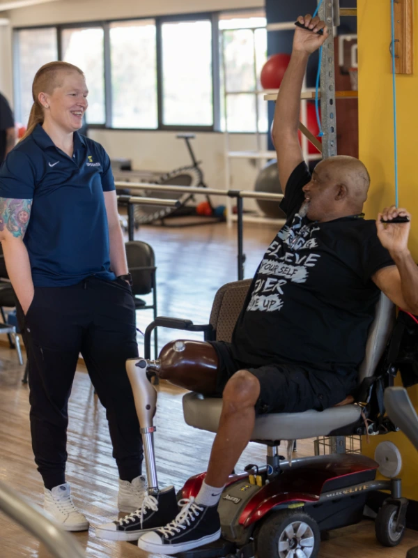 A therapist working with an amputee.