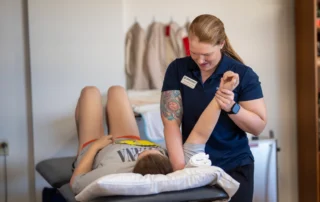 A certified hand therapist doing upper extremity manipulation on a patient.