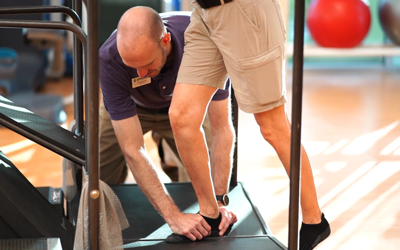 Therapist working on the foot of a patient with plantar fasciitis.