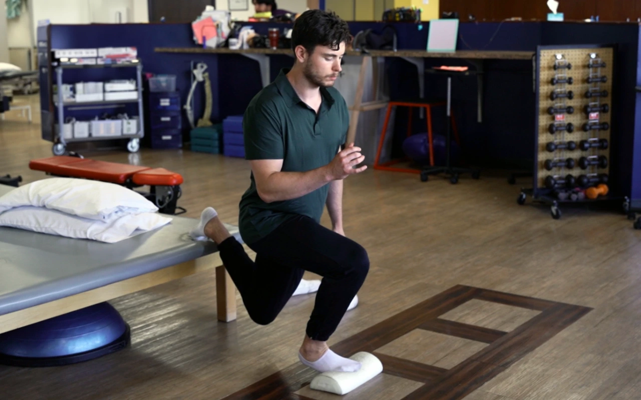 Image of a man doing single leg squats.