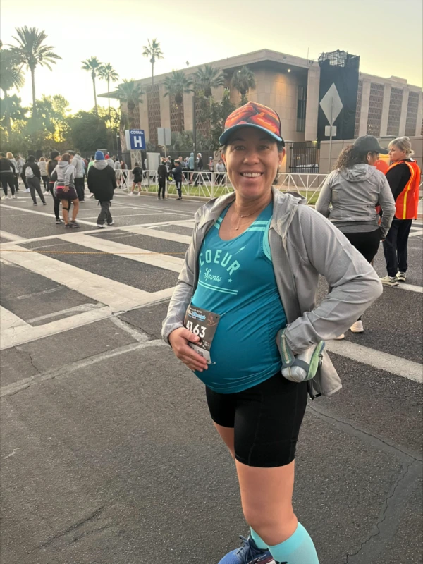 Pregnancy to Work body image 1 Maria Kline posing before a marathon.