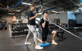 Image of a female therapist helping a triathlete train