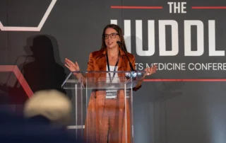 Bekah Hibbert speaking at The Huddle 2026.