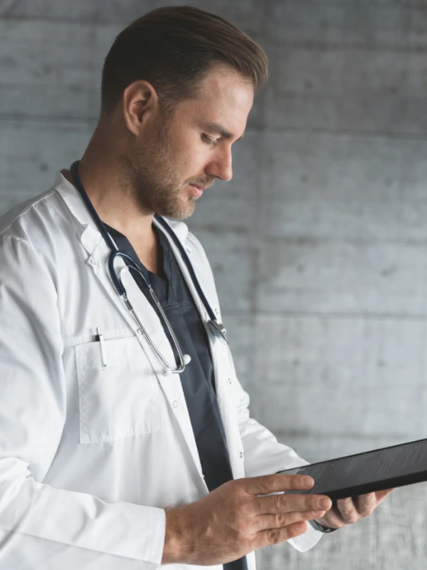 A doctor checking his clipboard.