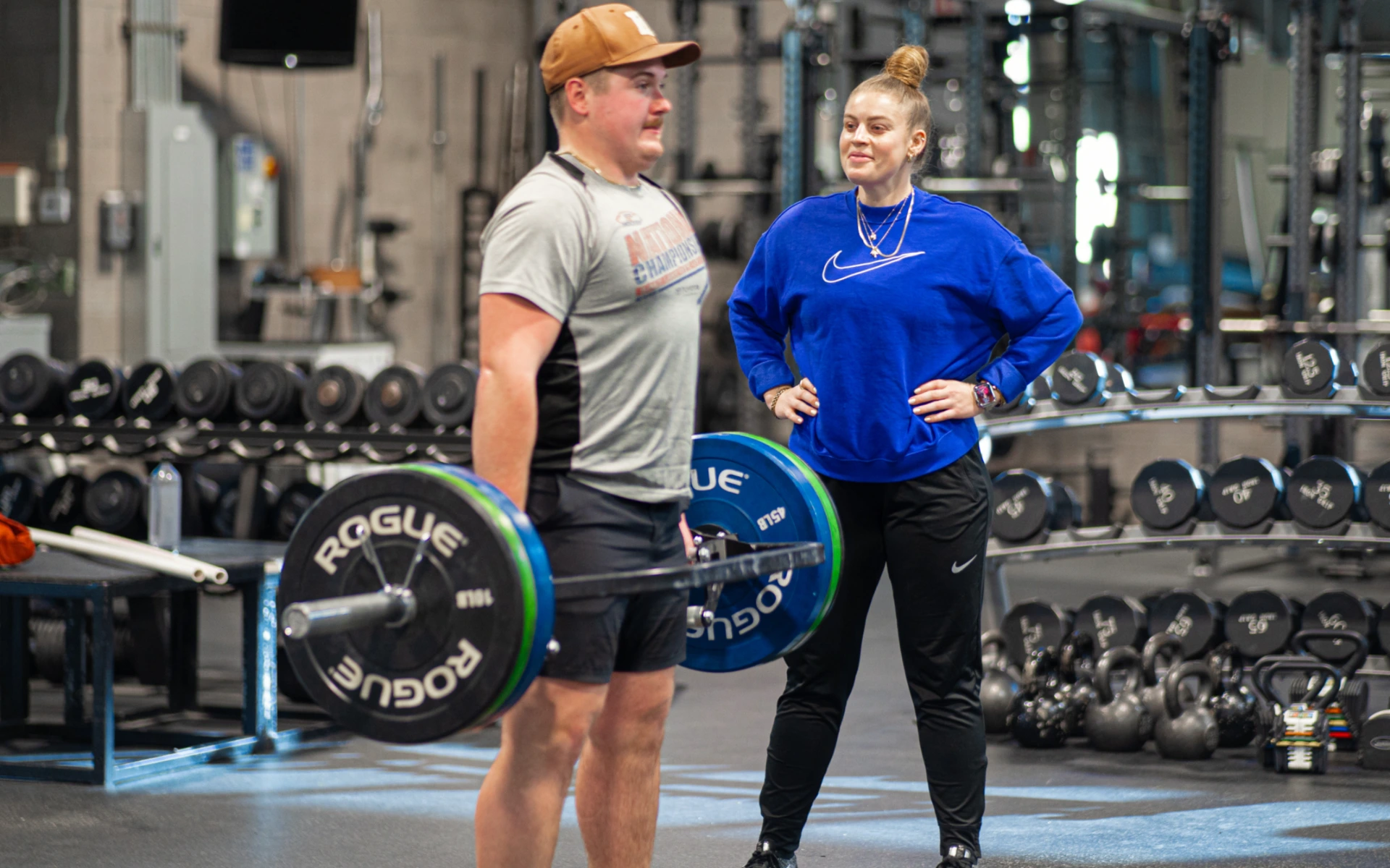 Kaitlyn Keyser, PT, DPT, SCS, ATC, CSCS with a male athlete as he performs deadlifts at the Spooner Sports Institute.