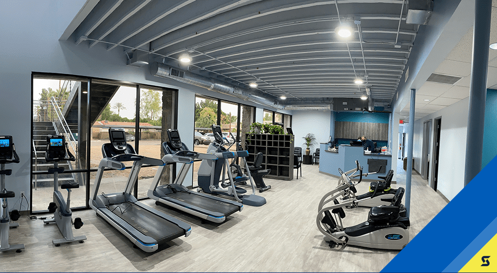 Sunnyslope_Clinic_Rebrand Row of treadmills, ellipticals, and bikes at Spooner Sunnyslope