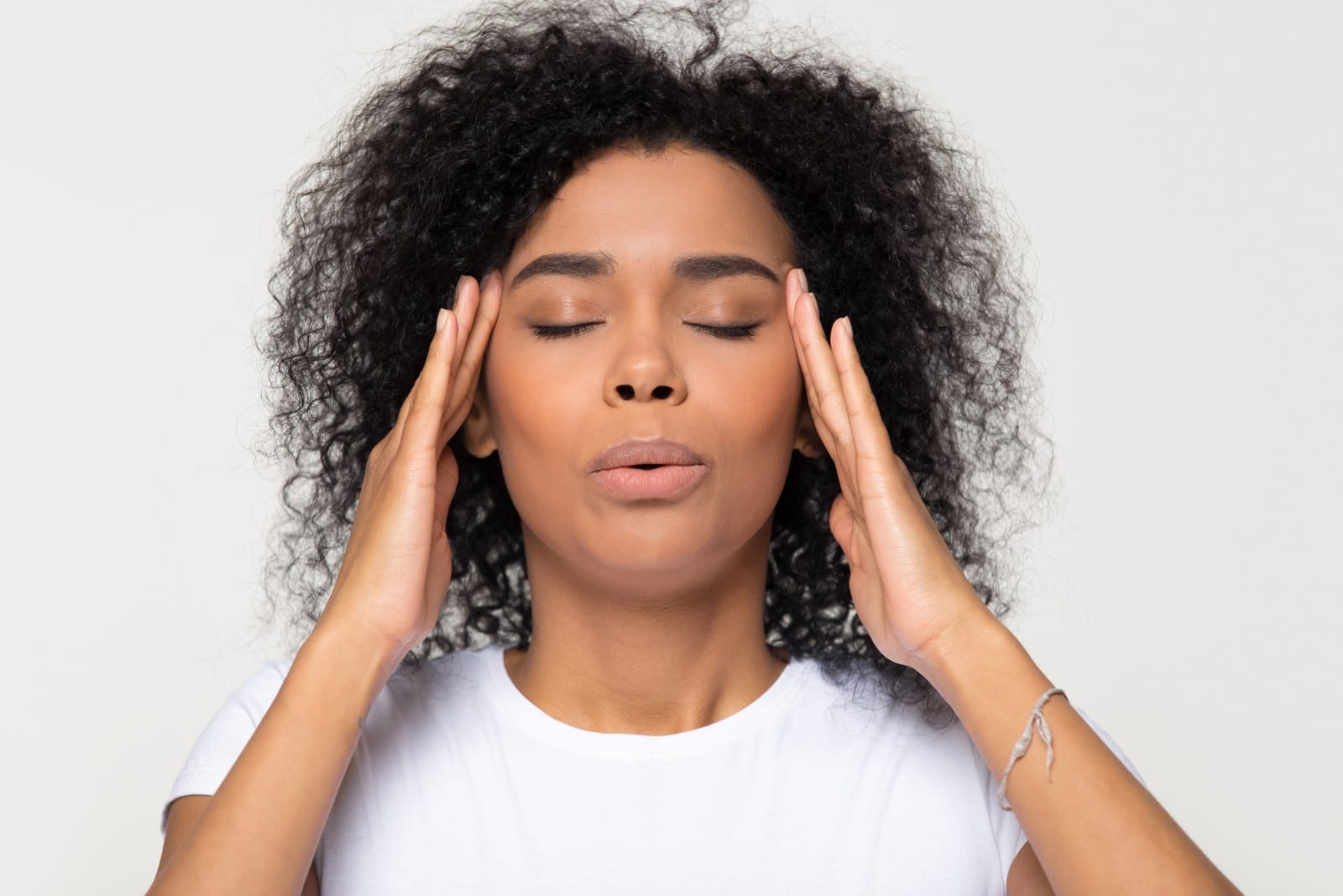 woman with hands to her temples