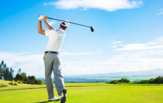 Golfer Hitting Golf Shot with Club on the Course