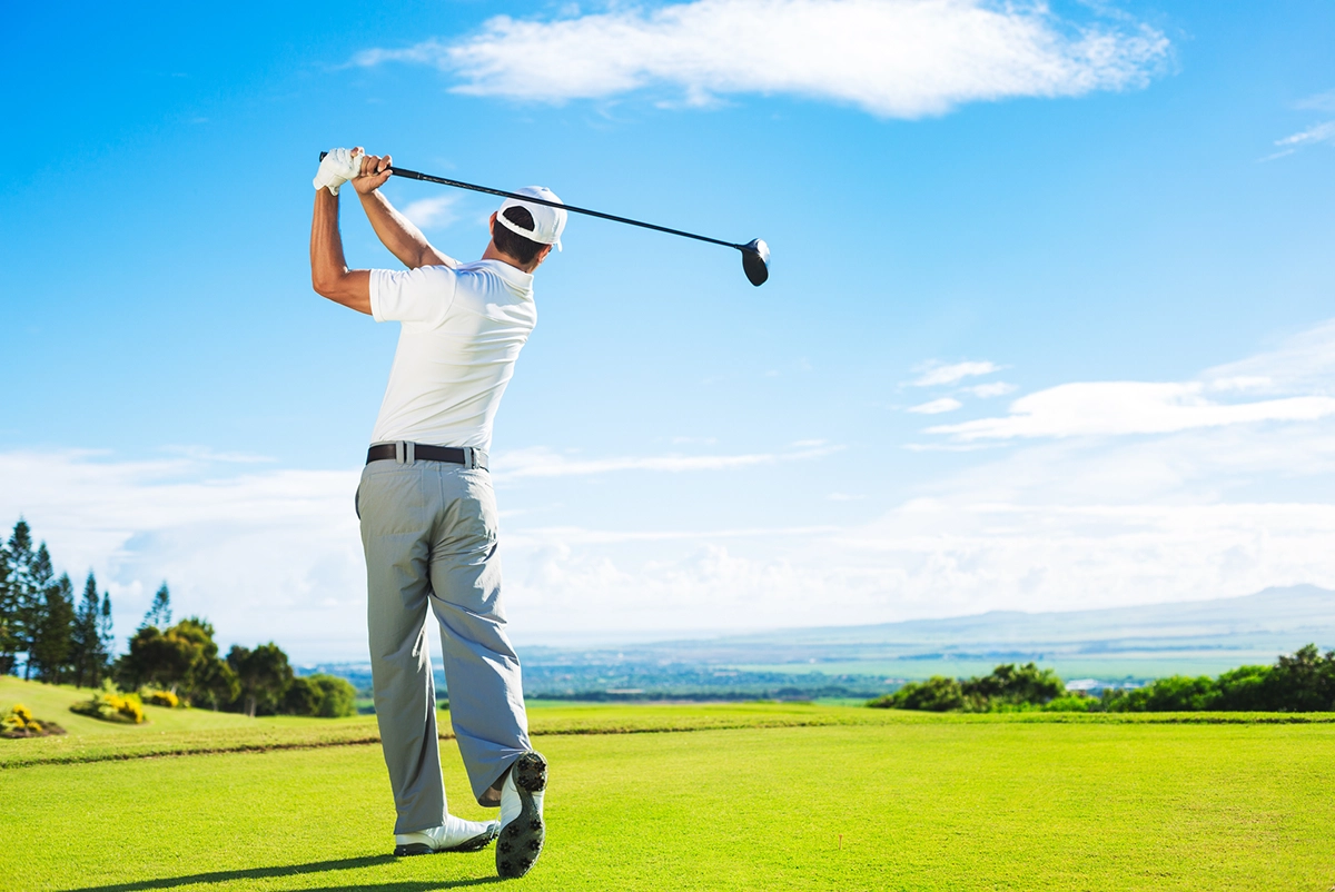 Golfer Hitting Golf Shot with Club on the Course