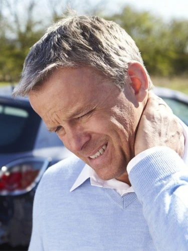 Man holding his neck after a car accident.