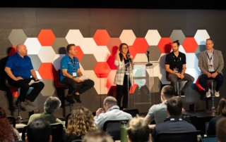 Feature image of a panel of presenters answering questions.