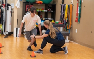 Feature image of a man with his legs crossed in a balance exercise.