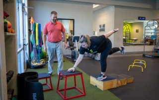 Image of therapist Nick Sutton watching a patient tap a blazepod.