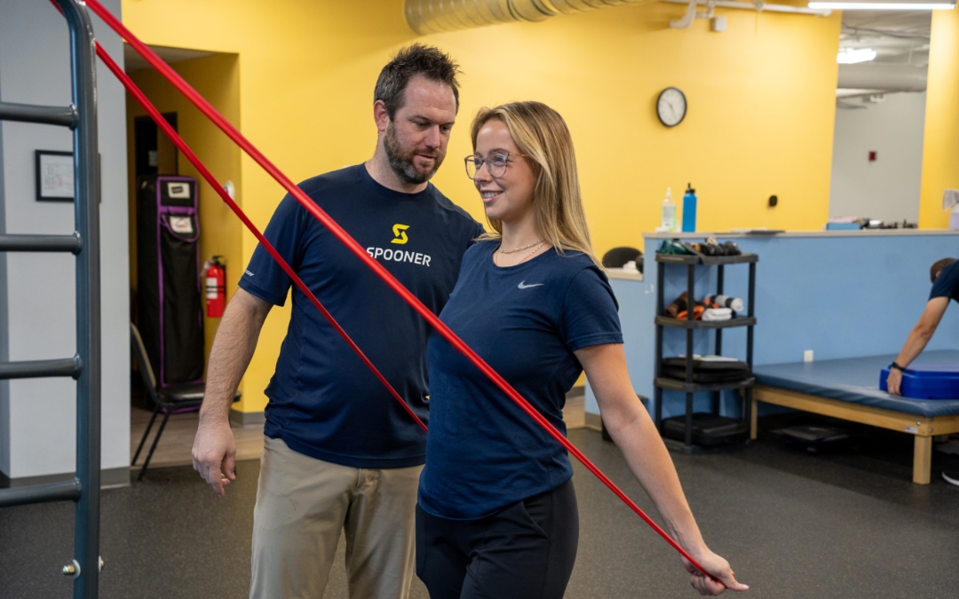 3 exercises for a better posture feature image of a woman stretching her arms back with resistance bands.