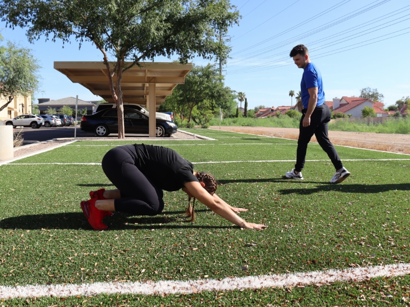 image of woman on the ground in backward dog pose.