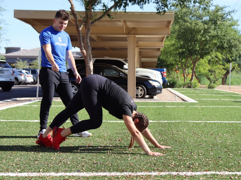 Image of woman on the ground in upward dog pose.