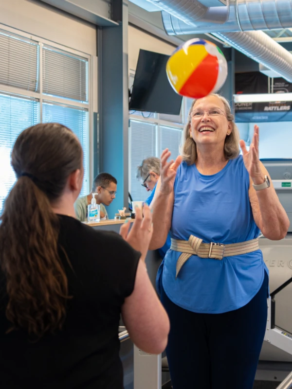 Image of a woman catching an inflatable ball.