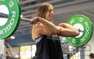 Feature image of a woman performing a deadlift.