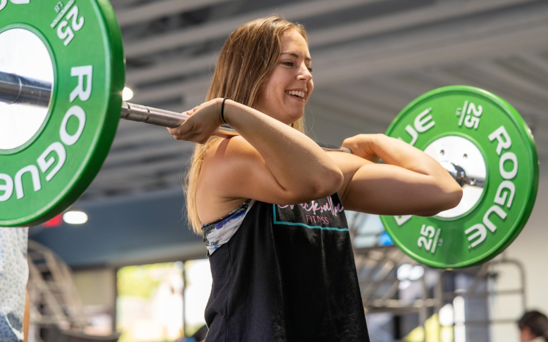 Feature image of a woman performing a deadlift.