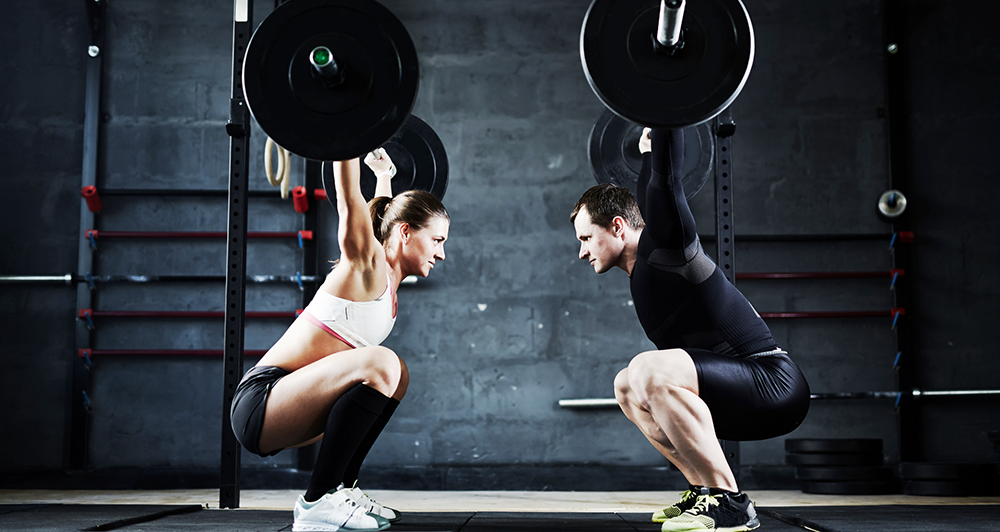 man and woman lifting weights - rotator cuff injuries and tears